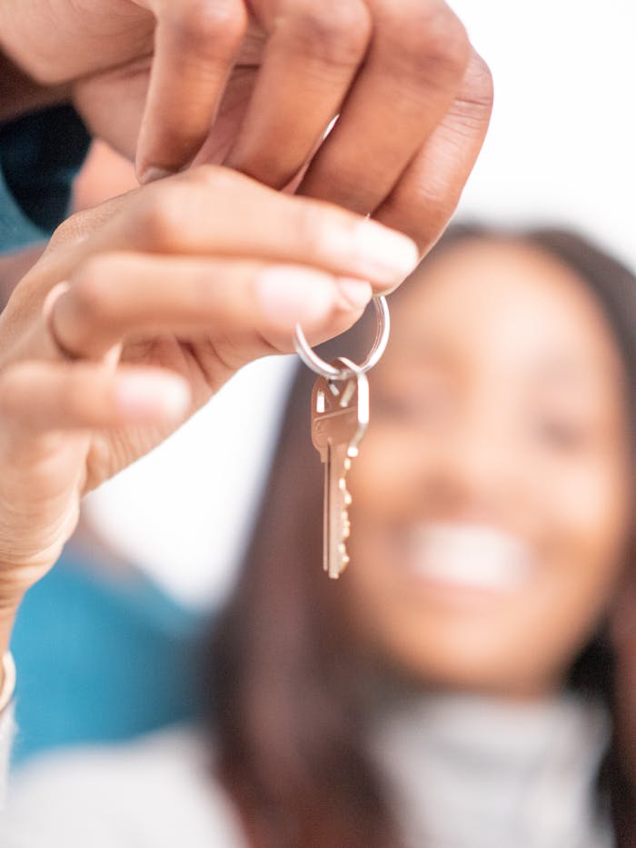 Joyful moment of new homeowners receiving keys to their new house, symbolizing hope and new beginnings.
